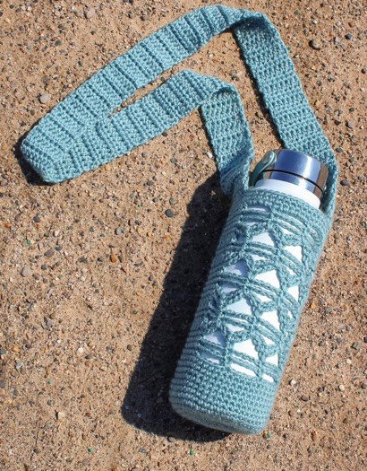 Crochet water bottle cozy holding a 40 oz Hydro Flask, worn crossbody by the strap