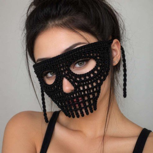 Woman wearing a black crochet skull lace mask with open eye holes, a lace nose and teeth along the lower edge.